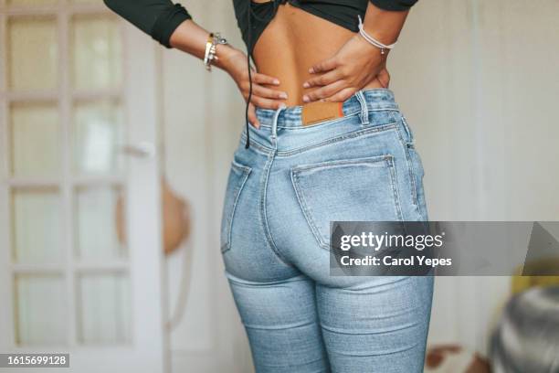 hispanic young woman having back pain - women injury bildbanksfoton och bilder