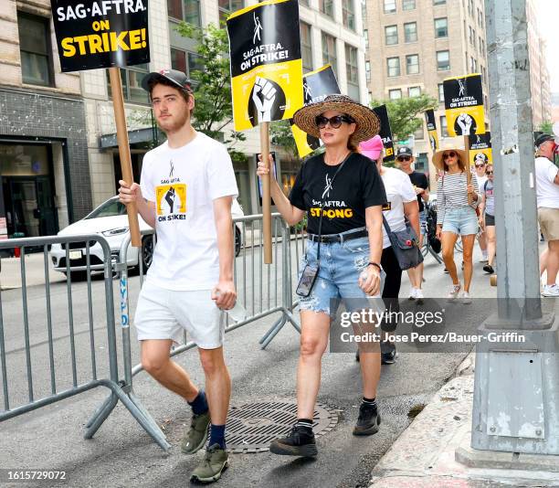 Roman Walker Zelman and Debra Messing are seen at the SAG-AFTRA picket line in Downtown, Manhattan on August 21, 2023 in New York City.