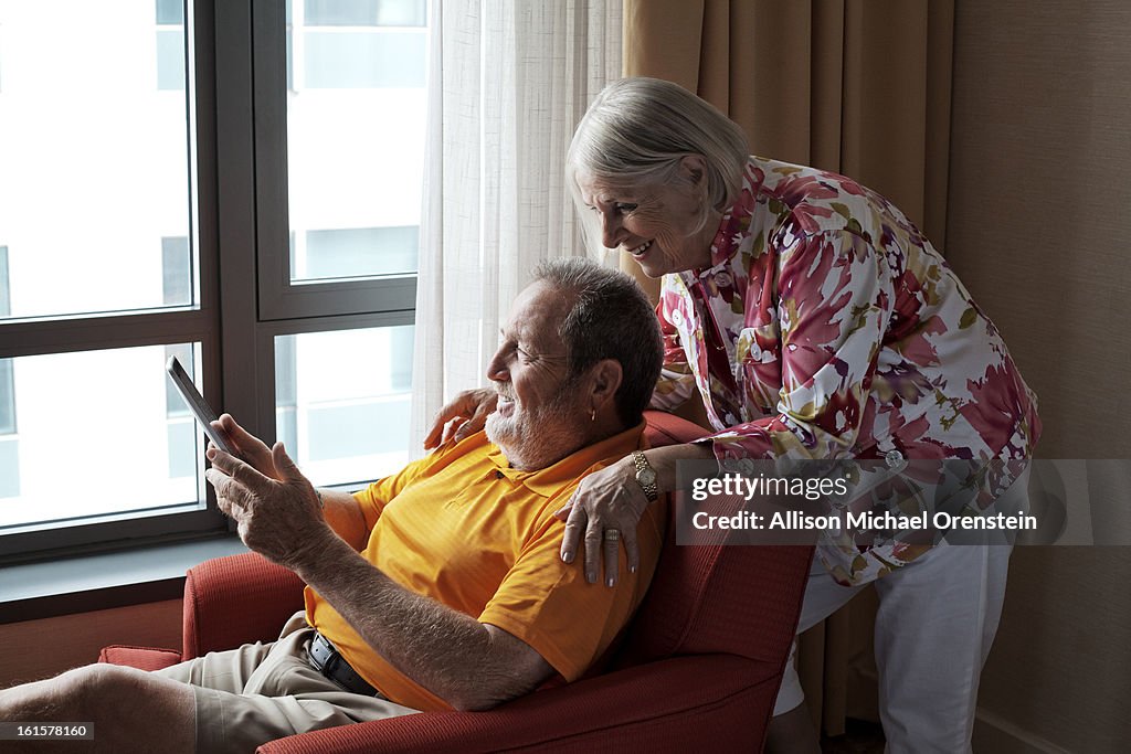Elderly couple looking at tablet computer