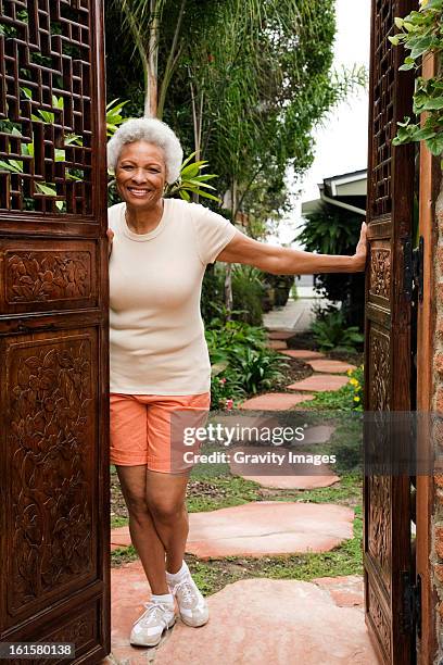 senior woman outdoors at home - black shorts stock pictures, royalty-free photos & images