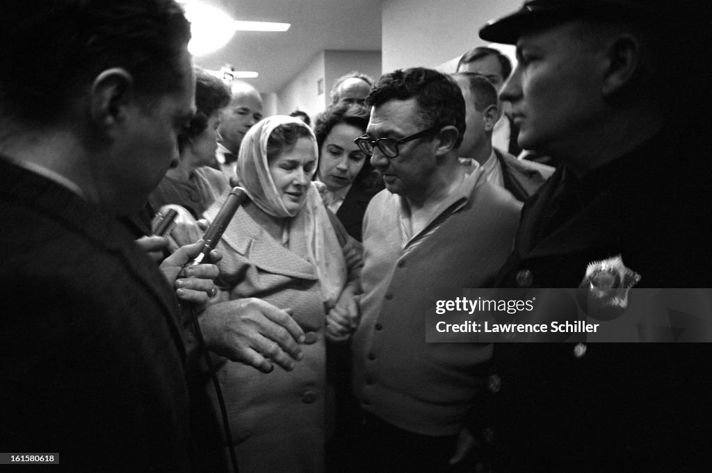 Earl Ruby Crowded by police and members of the press, Eva Grant and Earl Ruby ...