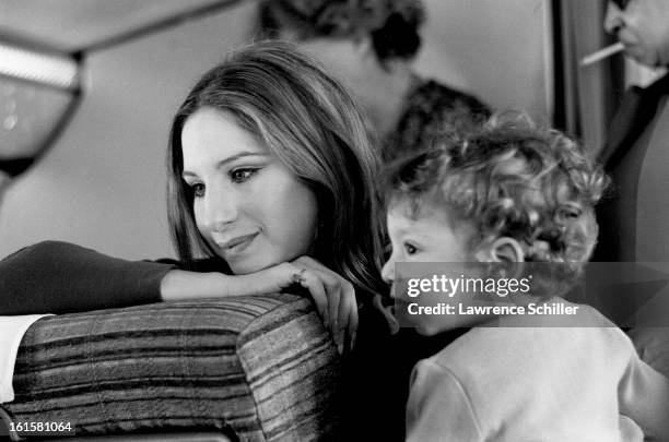 En route to London, American actress and singer Barbra Streisand poses for her son , Jason Gould, 1969.