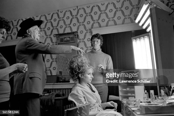 American singer and actress Barbra Streisand in front of her makeup mirror while British photographer and costume designer Cecil Beaton and American...
