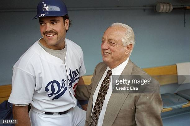 Former manager Tommy Lasorda and catcher Mike Piazza of the Los Angeles Dodgers pose together for a picture during the retiring of Lasorda's number...