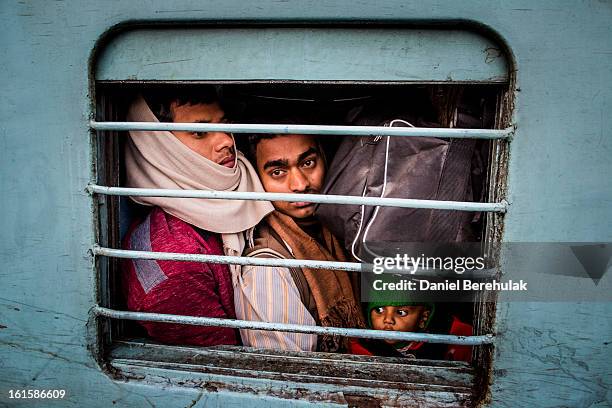 Hindu devotees cram onto their train at Allahabad train station, the site of last night's stampede, during the Maha Kumbh Mela on February 11, 2013...