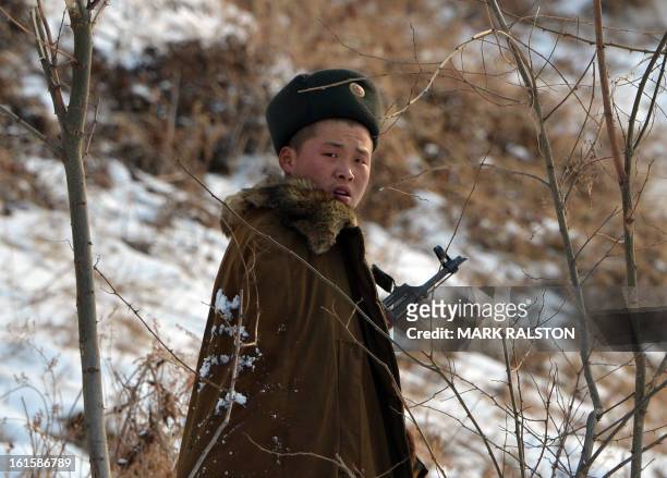 North Korean soldier reacts as he patrols along the Yalu River near the North Korean town of Sinuiju after the country conducted it's third nuclear...