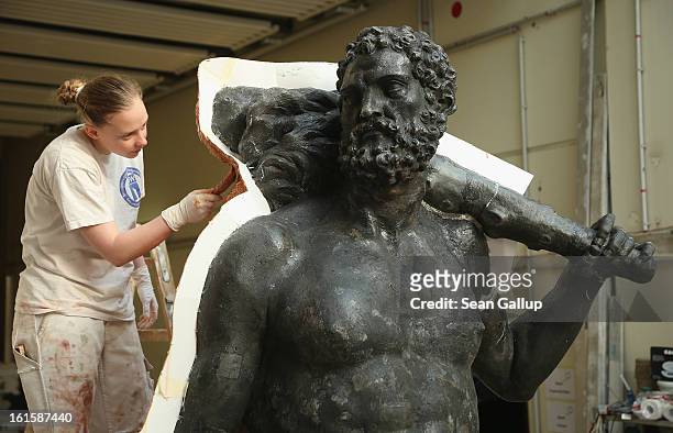 An artisan prepares a casting moulds on an original sculpture of Herkules at the Schlossbauhuette studio where a team of sculptors is creating...
