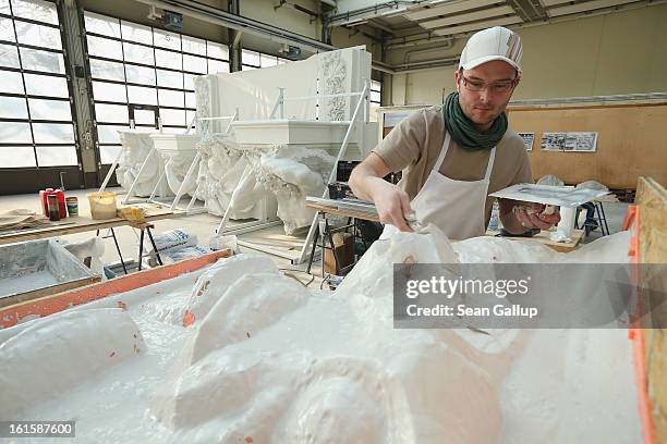 Stucco master Andre Ermicher fortifies the underside of a silicon mould with plaster at the Schlossbauhuette studio where a team of sculptors is...