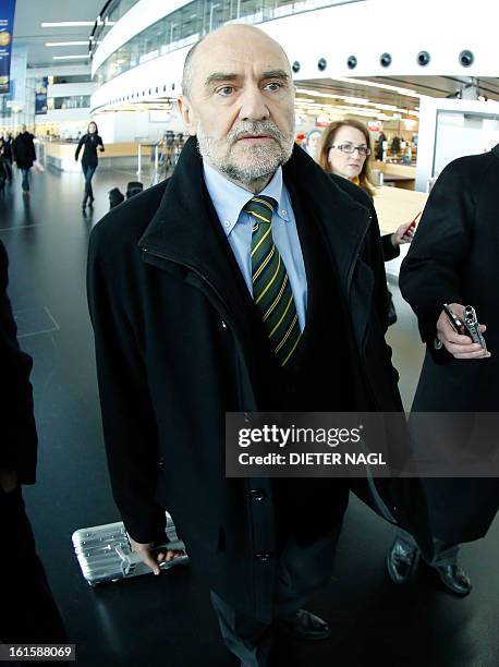 Deputy Director General and Head of the Department of Safeguards Herman Nackaerts talks with journalists as he leaves for another trip with his team...