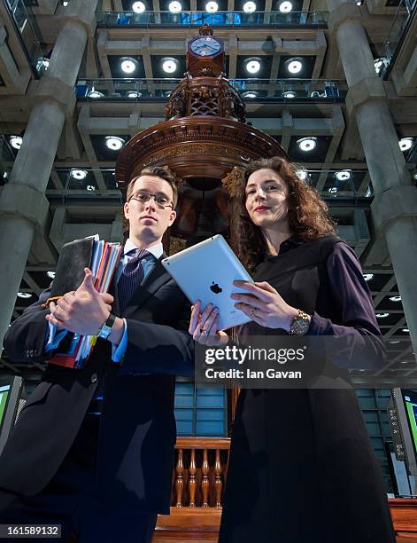 Alexandra Considine demonstrates the new iPad application to a colleague during the Xchanging Insurance iPad Application Launch at Lloyd's of London...