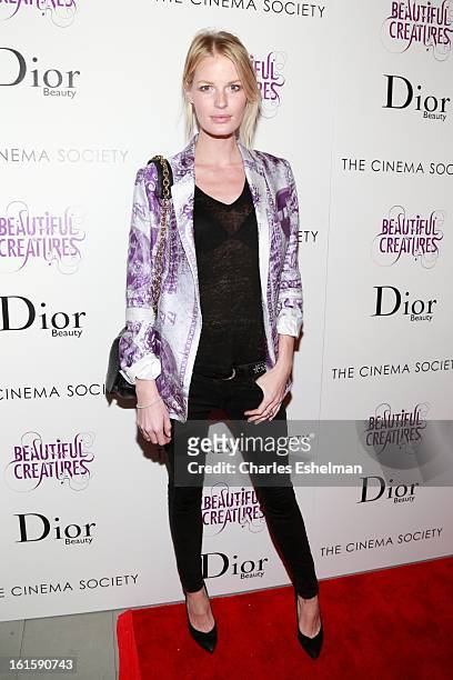 Model Caroline Weinberg arrives at The Cinema Society And Dior Beauty host a screening of "Beautiful Creatures" at Tribeca Cinemas on February 11,...