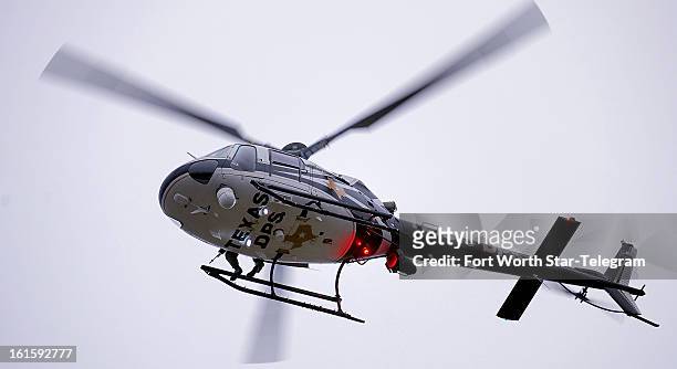 Helicopter escorts the procession for Chris Kyle in Midlothian, Texas, Tuesday, February 12, 2013. A motorcade of about 200 vehicles accompanied the...