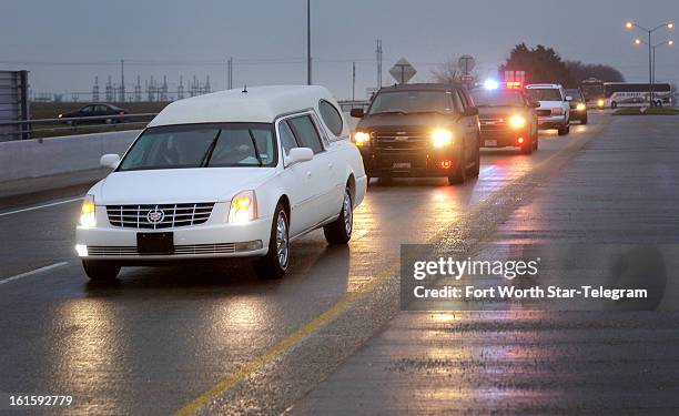 The hearse containing Chris Kyle's casket leaves the Multi-Purpose Stadium in Midlothian, Texas, Tuesday, February 12, 2013.