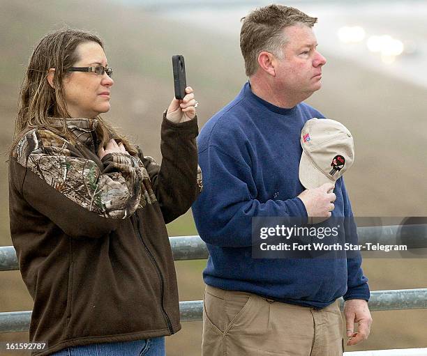 Tracy, right, and Lucinda Larimore, of Henderson, Nevada, friends of Chris Kyle, pay their respects as the funeral procession passed on US 287 in...