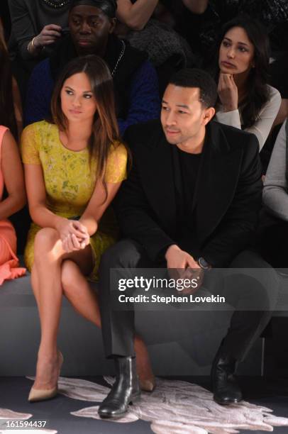 Model Chrissy Teigen and singer John Legend attend the Vera Wang Fall 2013 fashion show during Mercedes-Benz Fashion Week at The Stage at Lincoln...