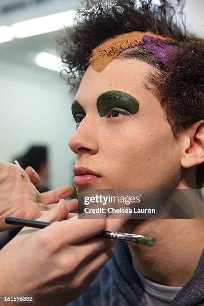 Model prepares backstage at the Siki Im Fall 2013 fashion show during Mercedes-Benz Fashion Week at Cafe Rouge on February 12, 2013 in New York City.