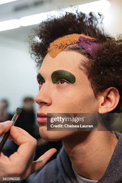 Model prepares backstage at the Siki Im Fall 2013 fashion show during Mercedes-Benz Fashion Week at Cafe Rouge on February 12, 2013 in New York City.