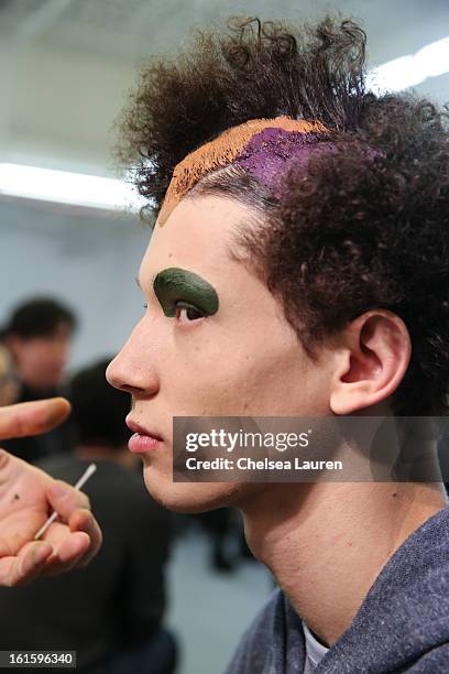 Model prepares backstage at the Siki Im Fall 2013 fashion show during Mercedes-Benz Fashion Week at Cafe Rouge on February 12, 2013 in New York City.