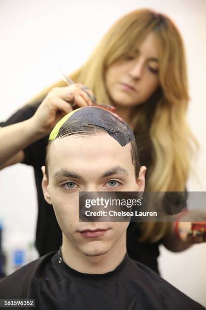 Model prepares backstage at the Siki Im Fall 2013 fashion show during Mercedes-Benz Fashion Week at Cafe Rouge on February 12, 2013 in New York City.