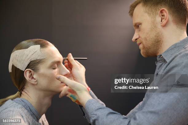 Model prepares backstage at the Siki Im Fall 2013 fashion show during Mercedes-Benz Fashion Week at Cafe Rouge on February 12, 2013 in New York City.