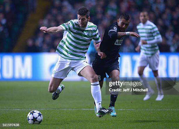 Charlie Mulgrew of Celtic competes with Arturo Vidal of Juventus during the UEFA Champions League Round of 16 first leg match between Celtic and...