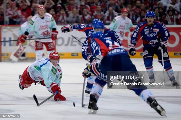 Philip Gogulla of Cologne jumps after the puck during the DEL match between Koelner Haie and Adler Mannheim at Lanxess Arena on February 12, 2013 in...