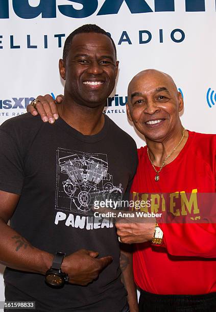 Musician Brian McKnight and Harlem Globe Trotter Curly Neal visit SiriusXM Studios on February 12, 2013 in New York City.