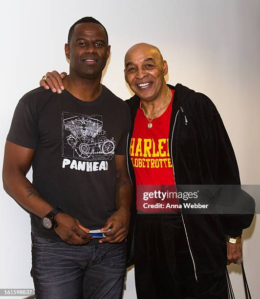 Musician Brian McKnight and Harlem Globe Trotter Curly Neal visit SiriusXM Studios on February 12, 2013 in New York City.