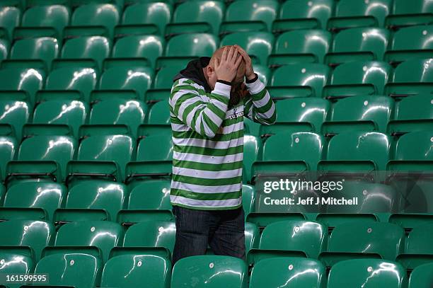 Celtic fan looks dejected at the end of the UEFA Champions League Round of 16 first leg match between Celtic and Juventus at Celtic Park Stadium on...