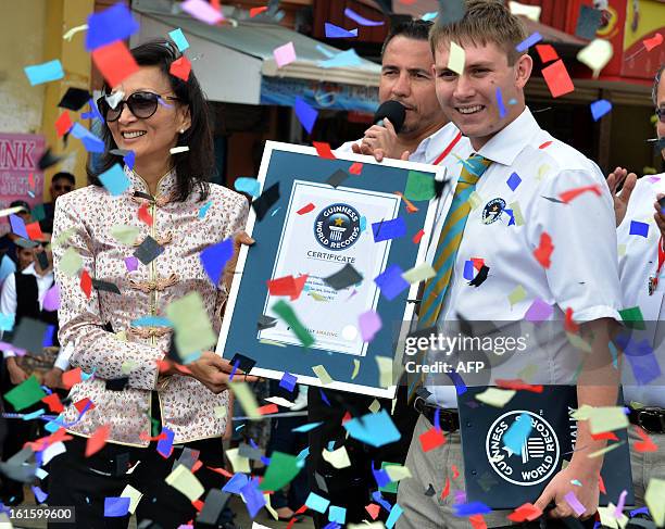 President of the Costa Rican Chinese Community, Isabel Yung , receives a Guinness record certificate from Guinness representative Ralph Hannah in San...