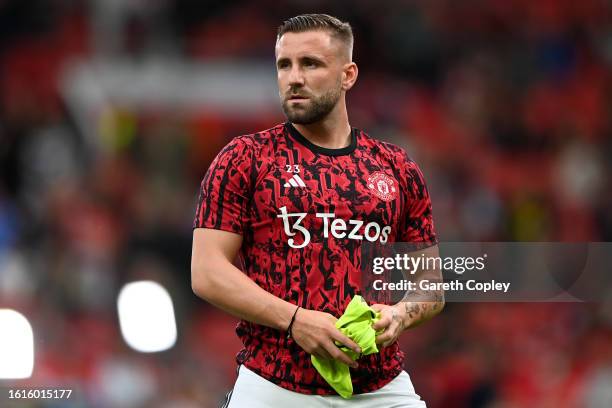 Luke Shaw of Manchester United warms up ahead of the Premier League match between Manchester United and Wolverhampton Wanderers at Old Trafford on...