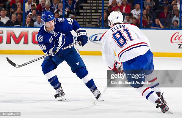 Teddy Purcell of the Tampa Bay Lightning attempts to guard Lars Eller of the Montreal Canadiens during the first period of the game at the Tampa Bay...