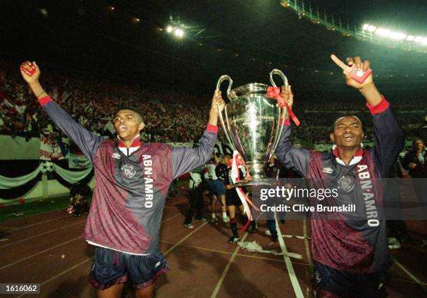 Nwankwo Kanu and Finidi George of Ajax lift the cup up after the European Cup Final between AC Milan and Ajax held on May 24, 1995 in Vienna,...