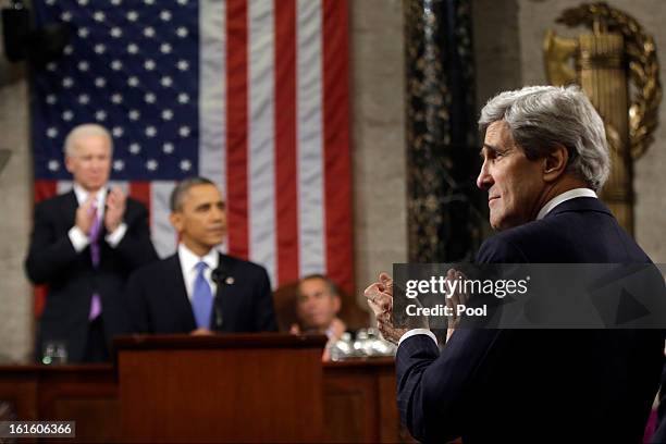 Secretary of State John Kerry applauds as U.S. President Barack Obama gives his State of the Union address during a joint session of Congress at the...