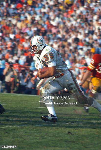 Larry Csonka of the Miami Dolphins carries the ball against the Washington Redskins during Super Bowl VII at the Los Angeles Memorial Coliseum in Los...