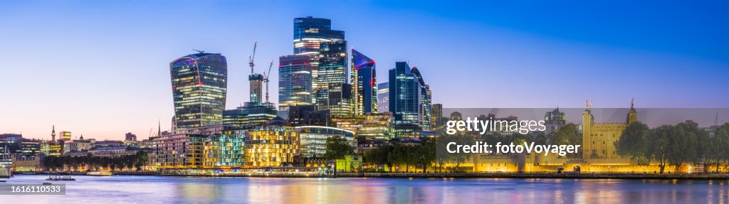 London City Financial District skyscrapers glittering over Thames sunset panorama