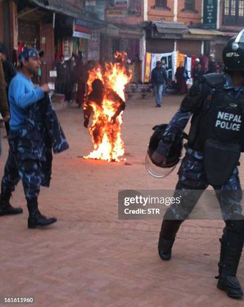 An exiled Tibetan monk sets himself on fire at Boudhanath Stupa in Kathmandu on February 13, 2013. A Tibetan monk doused himself in petrol in a...