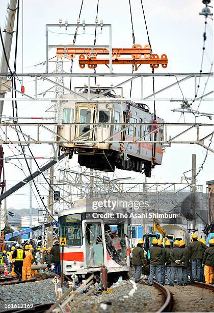 The carriage of the derailed Sanyo Electric Railway Co. Train is lifted to remove from the accident site a day after a collision with a truck at Arai...