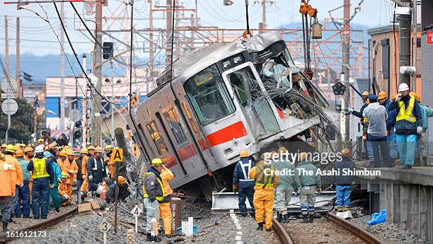 The carriage of the derailed Sanyo Electric Railway Co. Train is lifted to remove from the accident site a day after a collision with a truck at Arai...