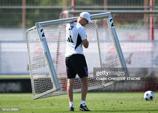 Bayern Munich's German head coach Thomas Tuchel carries a goal after a public training session at the club's grounds in Munich, southern Germany, on...