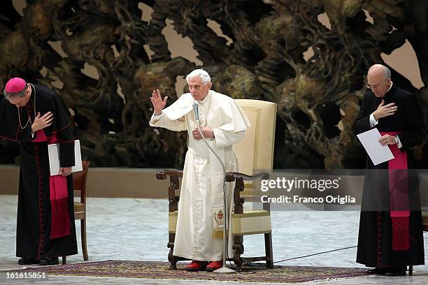 Pope Benedict XVI, flflanked by his personal secretary Georg Ganswein , delivers his blessing at the end of his weekly audience at the Paul VI Hall...