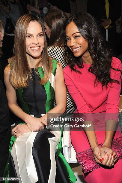 Hilary Swank and Zoe Saldana attend Michael Kors during Fall 2013 Mercedes-Benz Fashion Week at The Theatre at Lincoln Center on February 13, 2013 in...