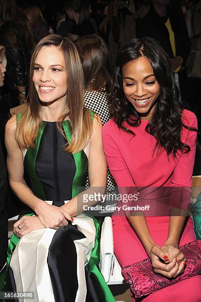 Hilary Swank and Zoe Saldana attend Michael Kors during Fall 2013 Mercedes-Benz Fashion Week at The Theatre at Lincoln Center on February 13, 2013 in...