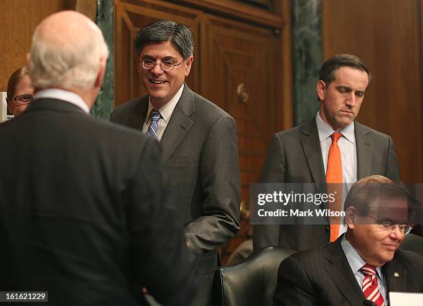 Treasury Secretary nominee Jack Lew talks to members after arriving at his confirmation hearing before the Senate Finance Committee, February 13,...