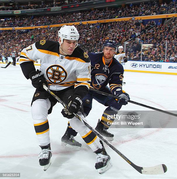 Milan Lucic of the Boston Bruins skates against Alexander Sulzer of the Buffalo Sabres on February 10, 2013 at the First Niagara Center in Buffalo,...