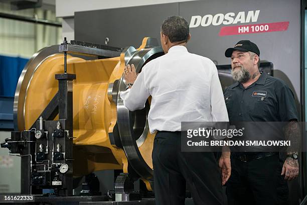 President Barack Obama is shown a product while touring the Linamar factory February 13, 2013 in Asheville, North Carolina. Obama toured the factory...