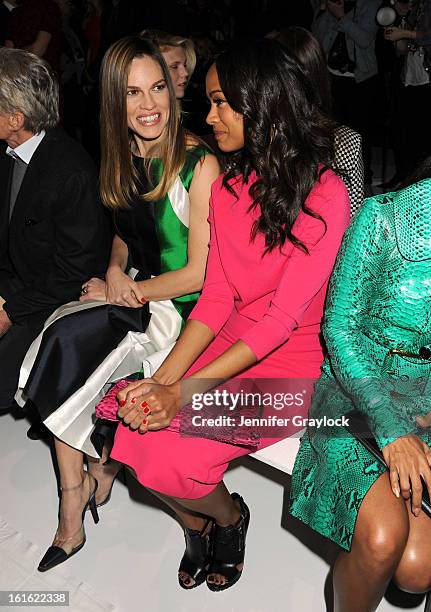 Actress Hilary Swank and Actress Zoe Saldana front row during the Michael Kors Fall 2013 Mercedes-Benz Fashion Show at The Theater at Lincoln Center...