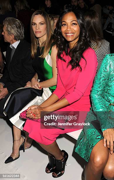 Actress Hilary Swank and Actress Zoe Saldana front row during the Michael Kors Fall 2013 Mercedes-Benz Fashion Show at The Theater at Lincoln Center...