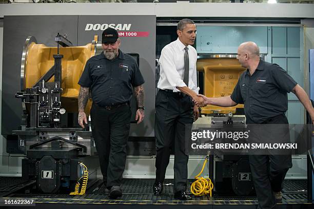 President Barack Obama greets employees while touring the Linamar factory February 13, 2013 in Asheville, North Carolina. Obama toured the factory...