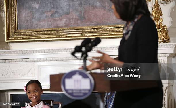 Star of the film Beasts of the Southern Wild Quvenzhane Wallis listens as U.S. First lady Michelle Obama speaks during an interactive student...